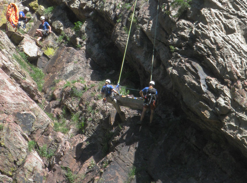 Redgarden Wall, rescuers lowering the injured climber in a litter