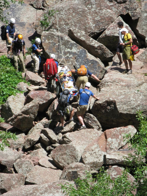 Redgarden Wall, rescuers evacuating the injured climber over scree